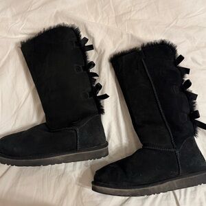 Ugg bailey bow II suede tall black boot with small tear on right boot